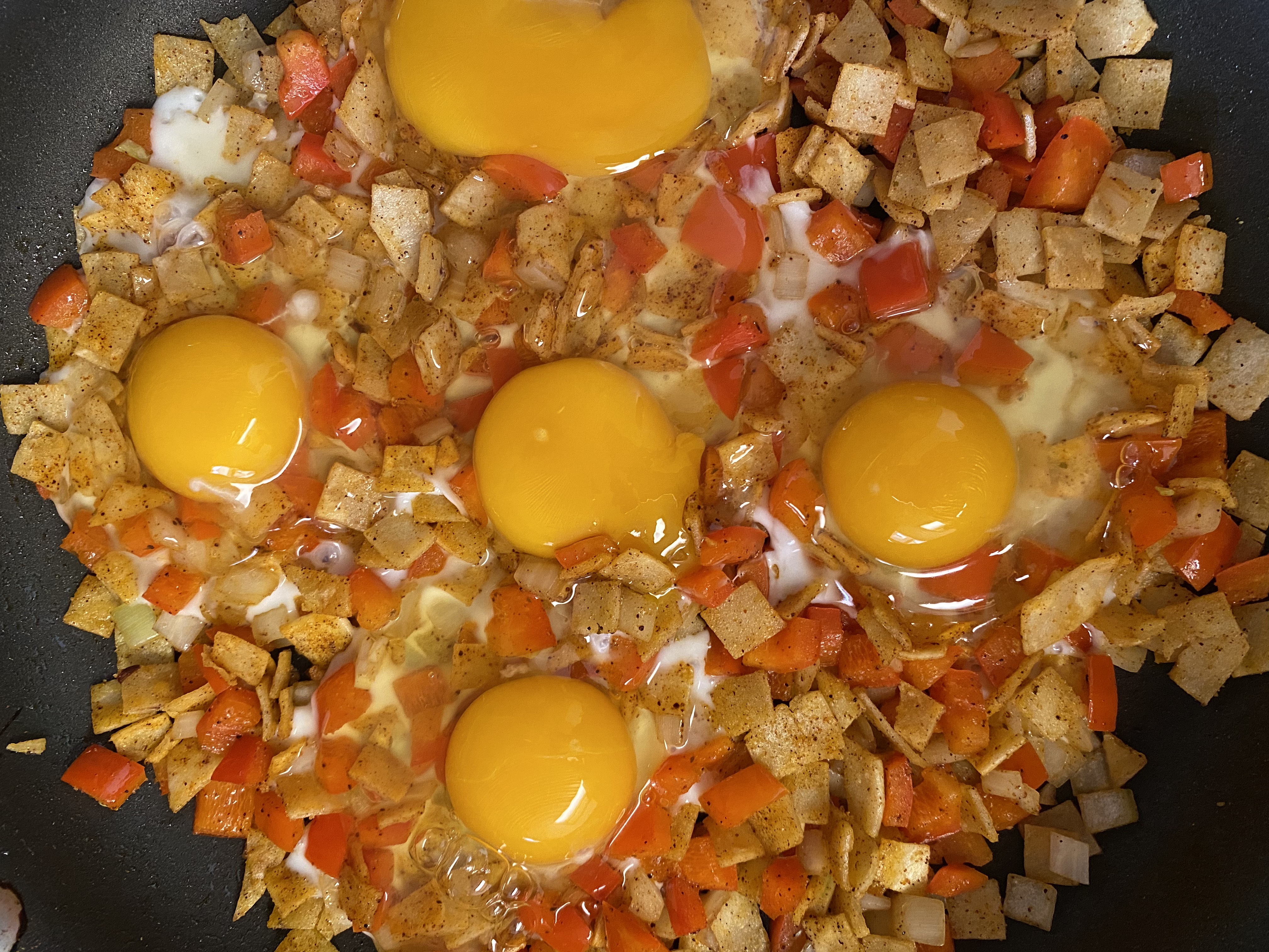 Chilaquiles cooking on a pan.